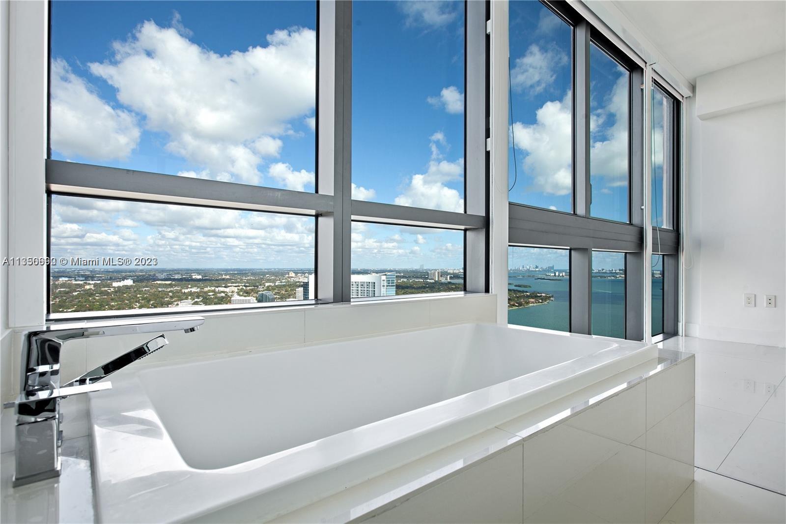 650 Northeast 32nd Street, Unit 4208 Miami, FL 33137 - Photo 9 of 18 a bath tub sitting next to a window