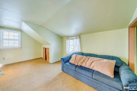 a bedroom with a bed and cabinet