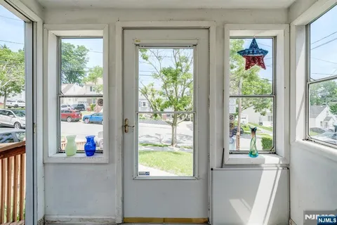 a living room with a large window and a flat tv screen