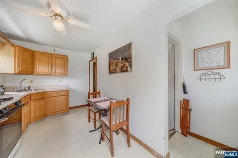 a kitchen with a table chairs refrigerator and cabinets