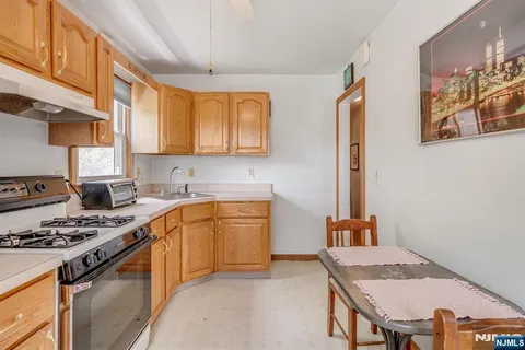 a kitchen with stainless steel appliances granite countertop a stove a sink dishwasher and cabinets