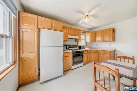 a kitchen with a refrigerator a stove top oven a sink and dishwasher