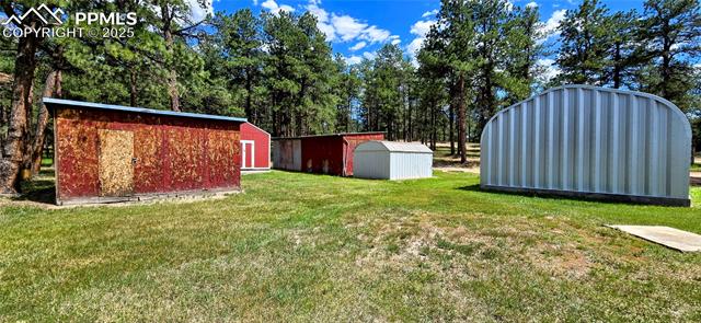11785 Milam Road Colorado Springs, CO 80908 - Photo 26 of 44 View of green lawn featuring a shed