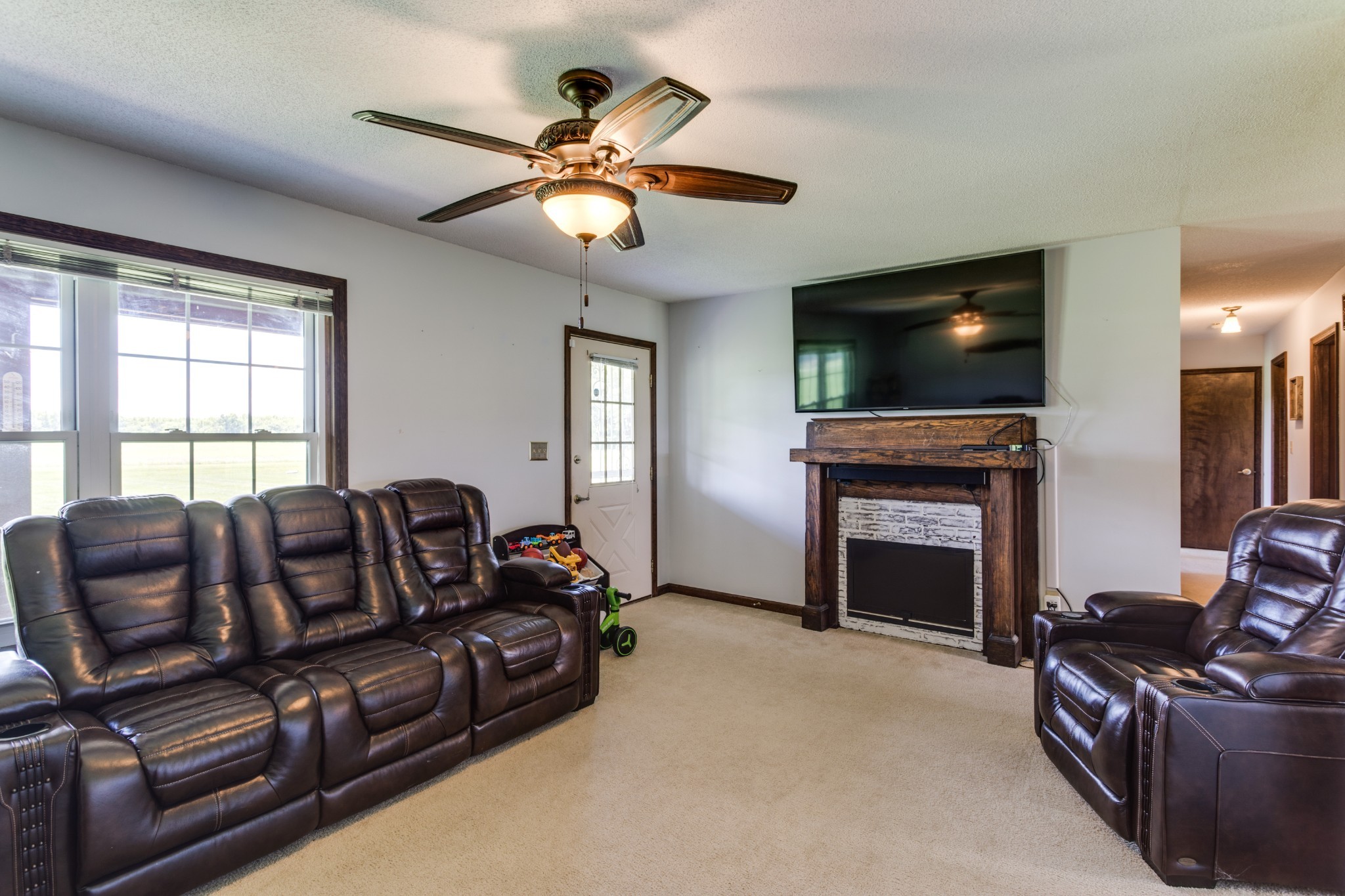 2987 Rock Road Morrison, TN 37357 - Photo 10 of 46 a living room with furniture a fireplace and a flat screen tv