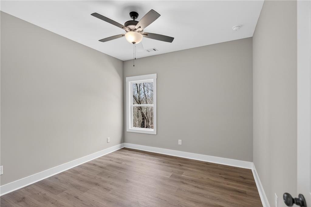 423 Relay Road Silver Creek, GA 30173 - Photo 34 of 48 an empty room with a window and a fan