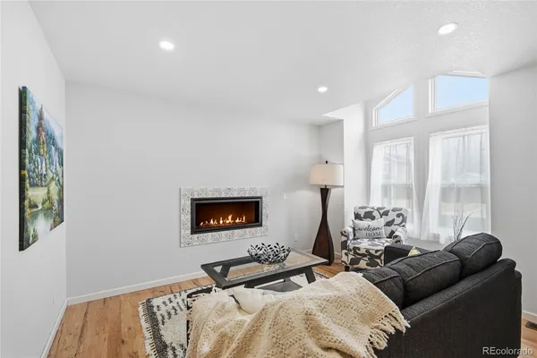 a bedroom with furniture and a large window