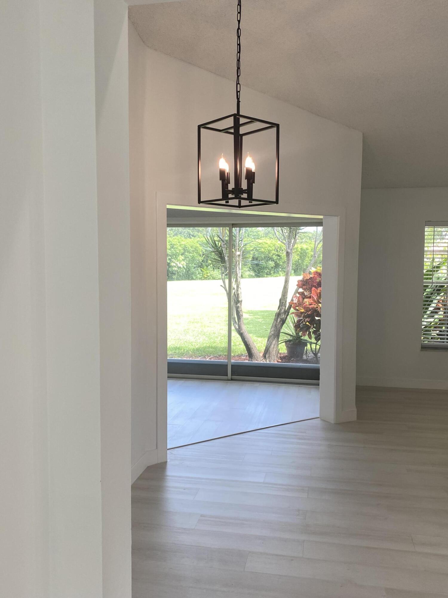 7591 Red Ruby Drive Delray Beach, FL 33446 - Photo 11 of 29 a view of a room with wooden floor wooden floor and windows