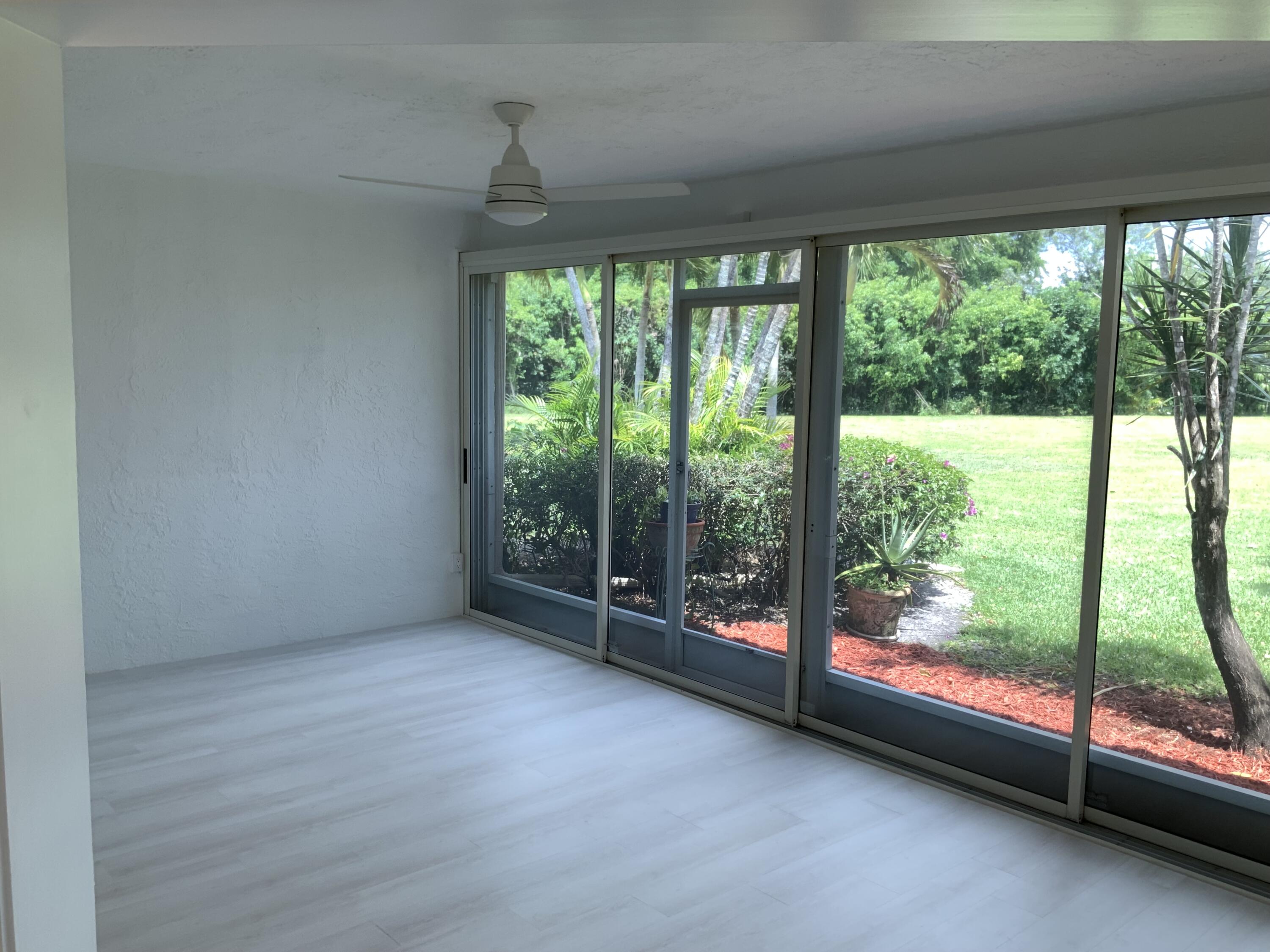 7591 Red Ruby Drive Delray Beach, FL 33446 - Photo 15 of 29 a view of a room with large windows