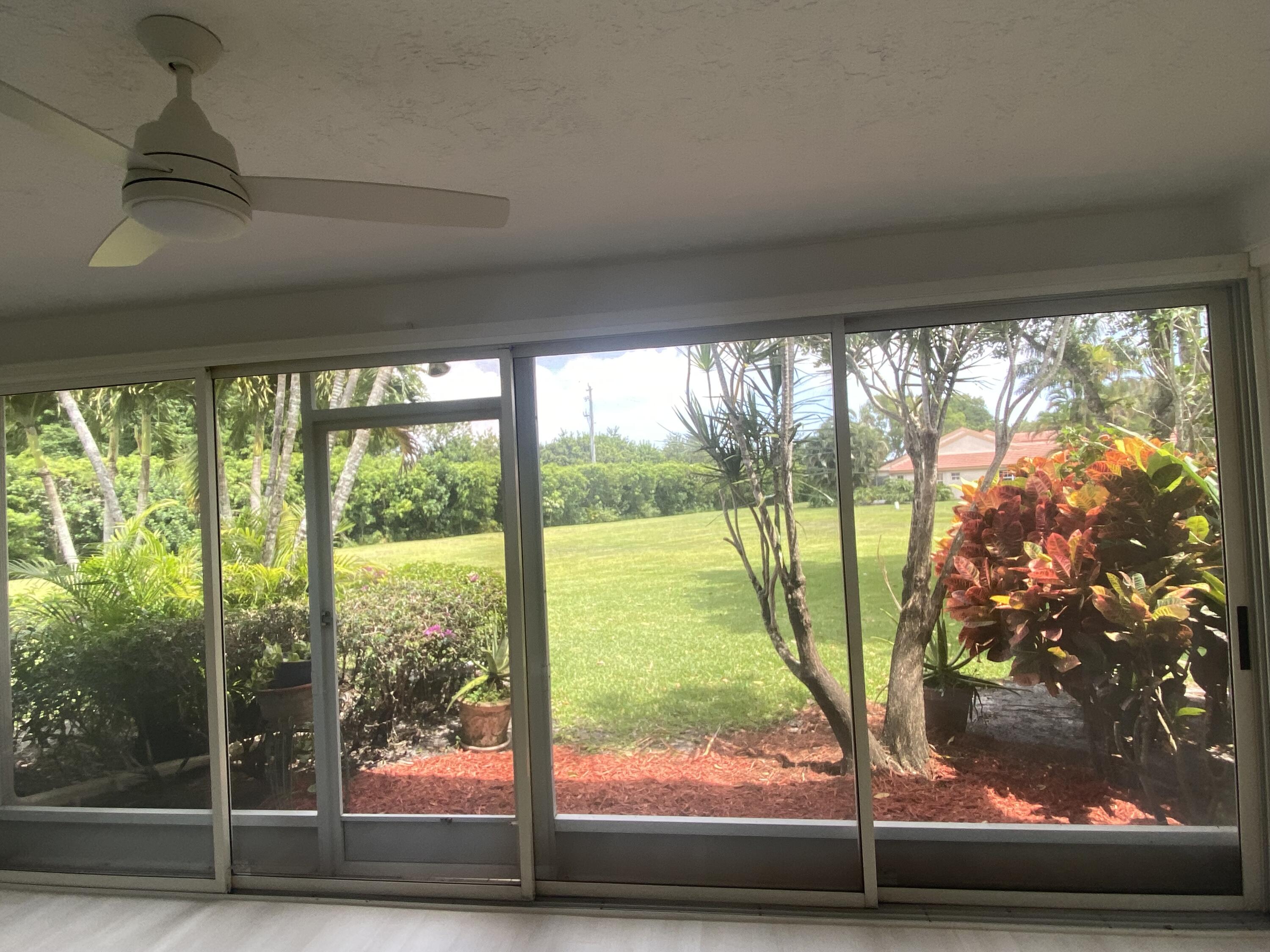7591 Red Ruby Drive Delray Beach, FL 33446 - Photo 2 of 29 a view of a porch with a yard