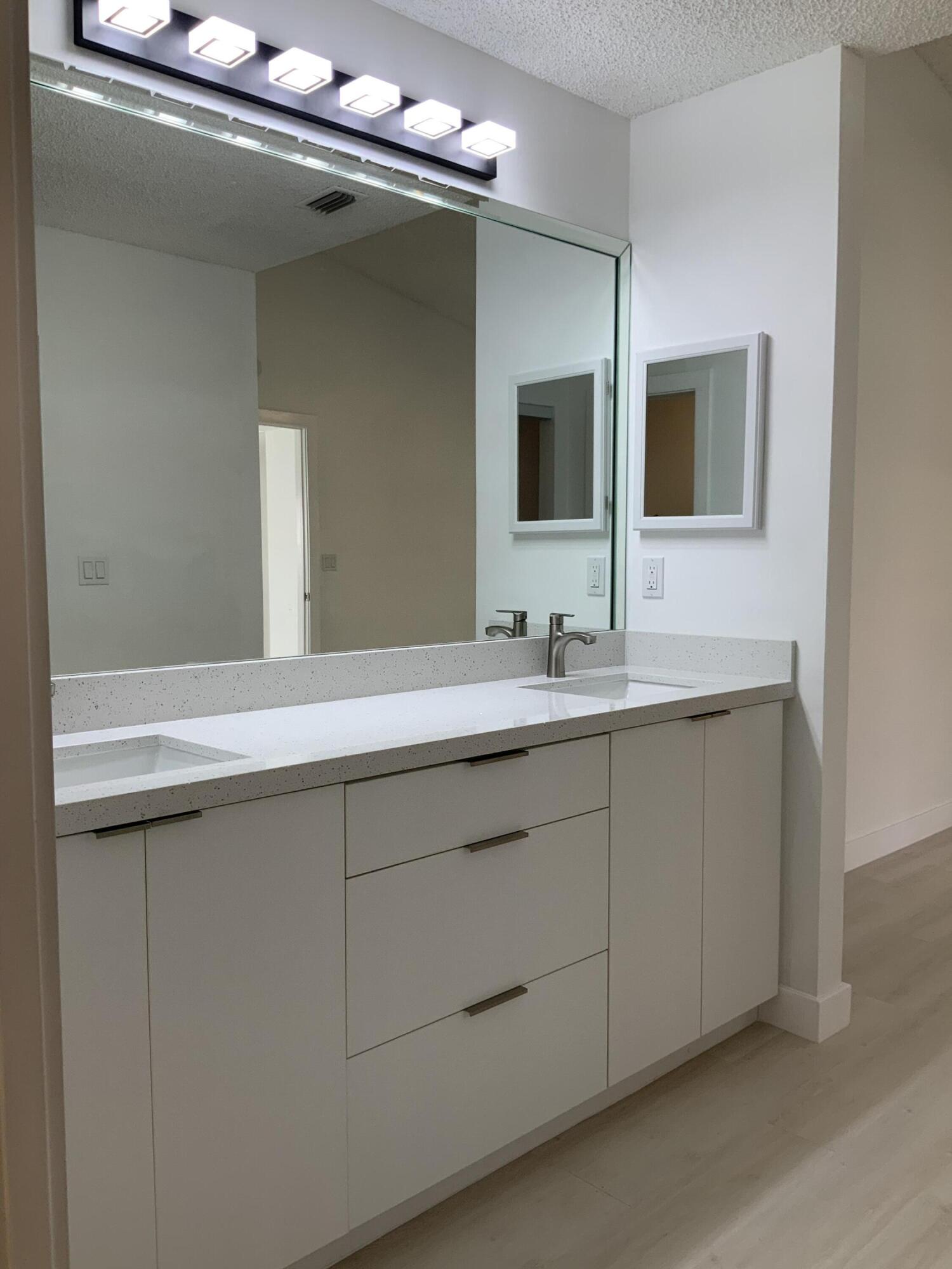 7591 Red Ruby Drive Delray Beach, FL 33446 - Photo 21 of 29 a bathroom with a double vanity sink and mirror