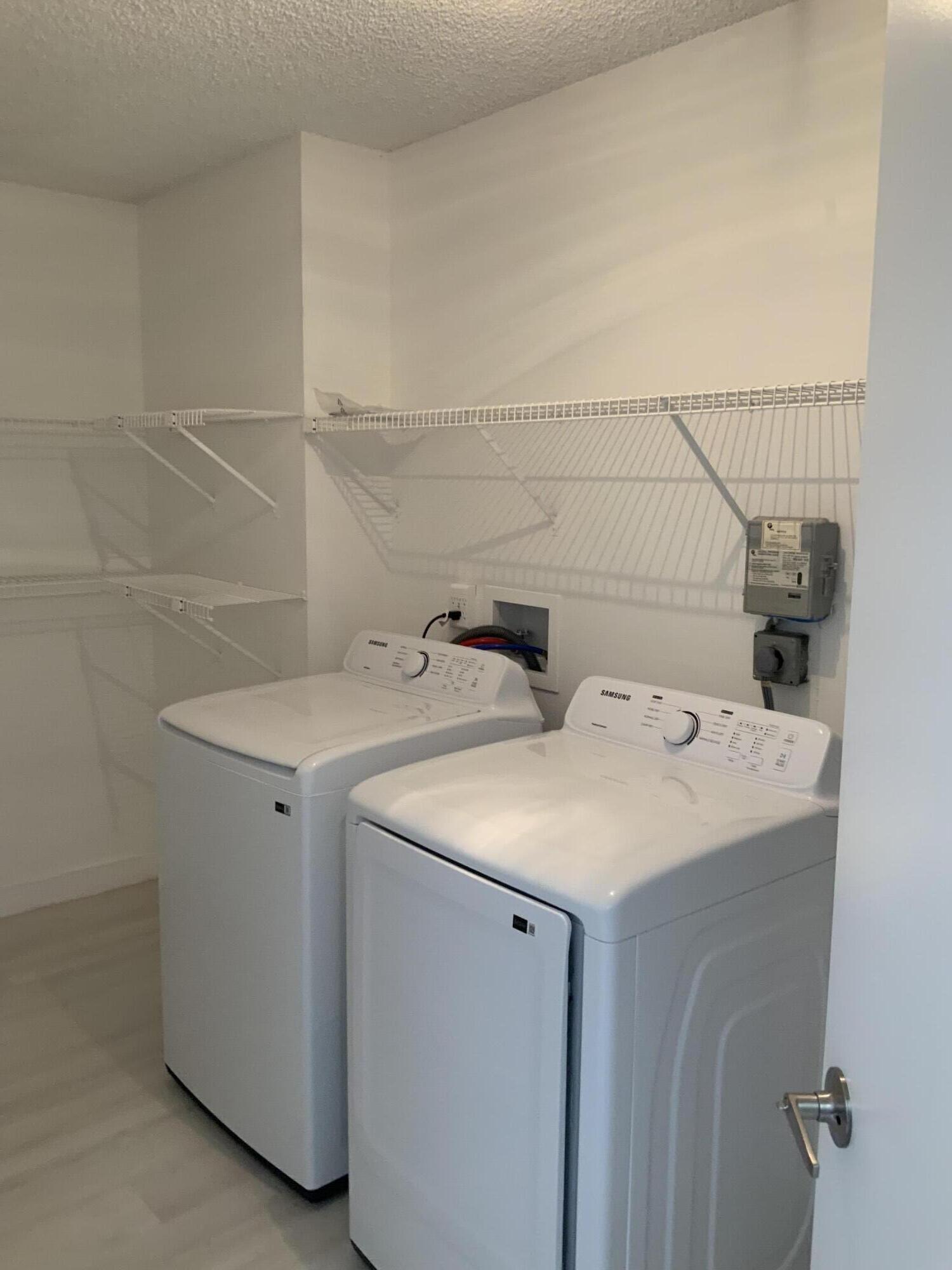 7591 Red Ruby Drive Delray Beach, FL 33446 - Photo 27 of 29 a utility room with dryer and washer