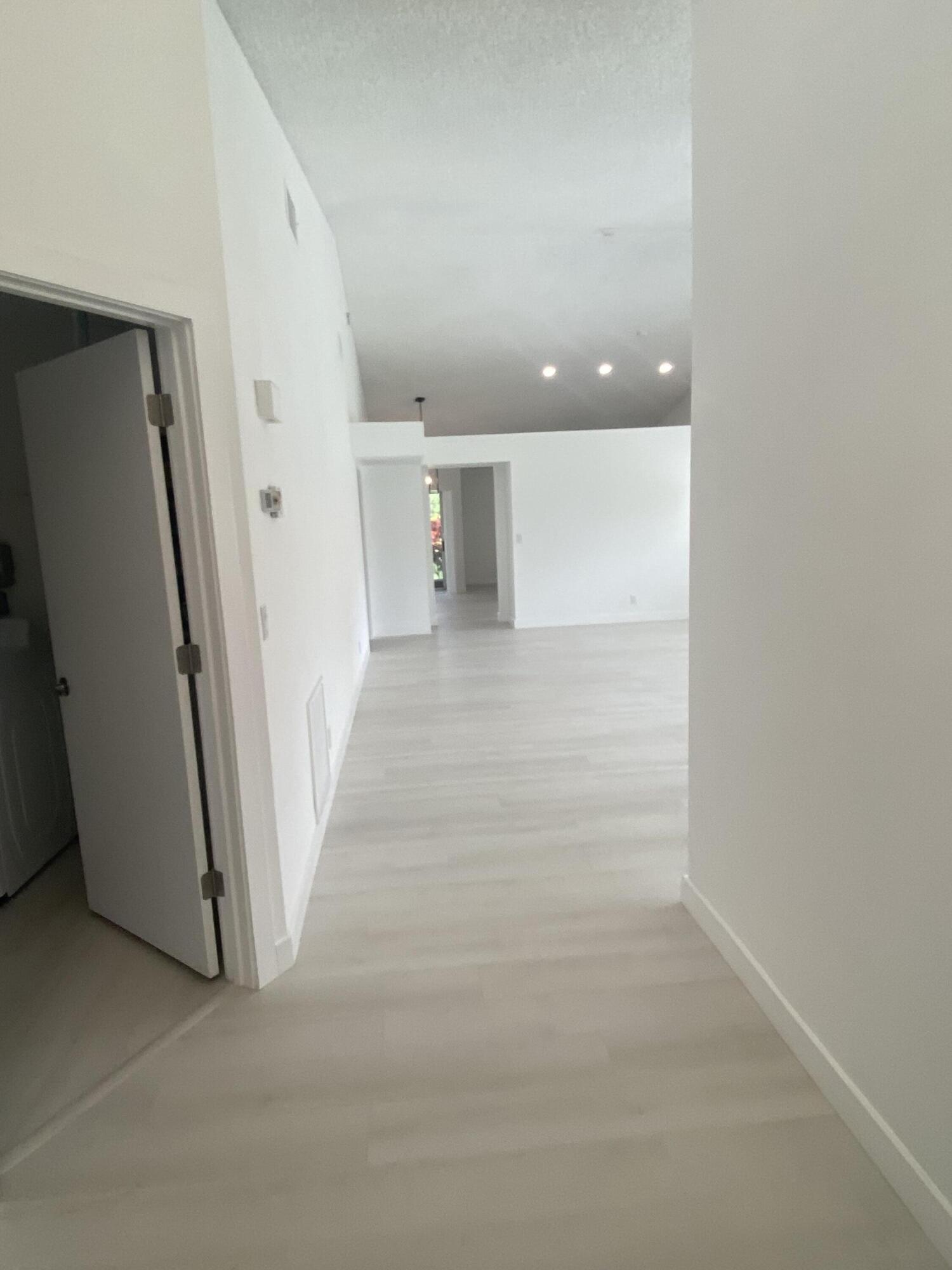 7591 Red Ruby Drive Delray Beach, FL 33446 - Photo 4 of 29 a view of a hallway with staircase