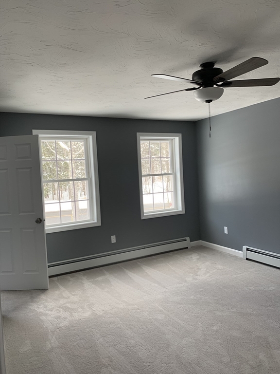 244 Holtshire Road, Unit LOT 4 Orange, MA 01364 - Photo 9 of 17 an empty room with windows and fan