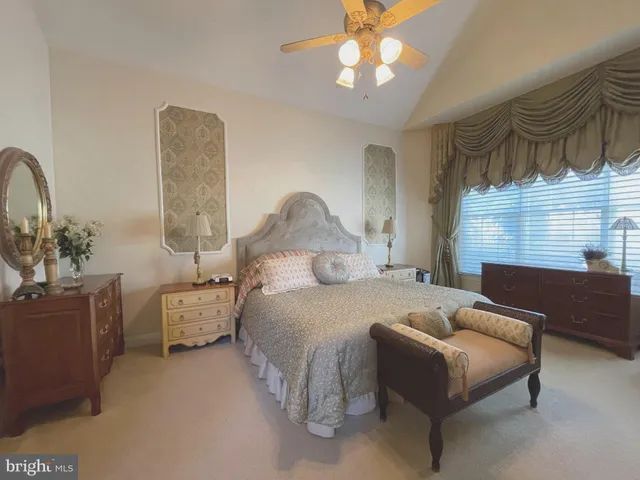 a bedroom with bed and window