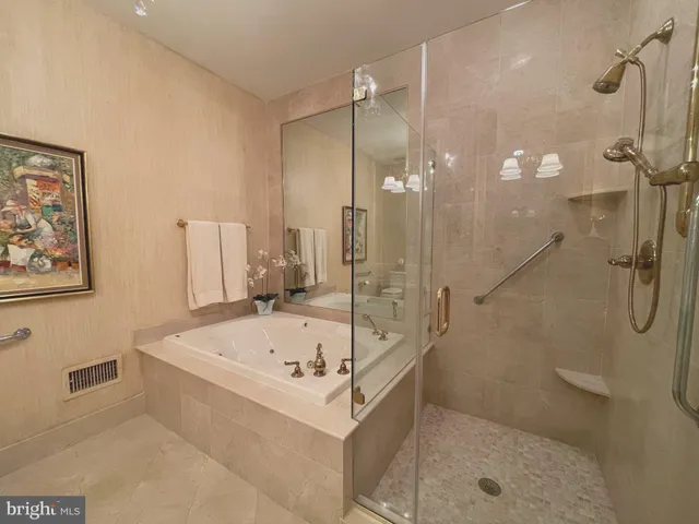 a bathroom with a tub a sink and a shower