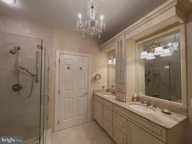 a spacious bathroom with a shower a sink and mirror