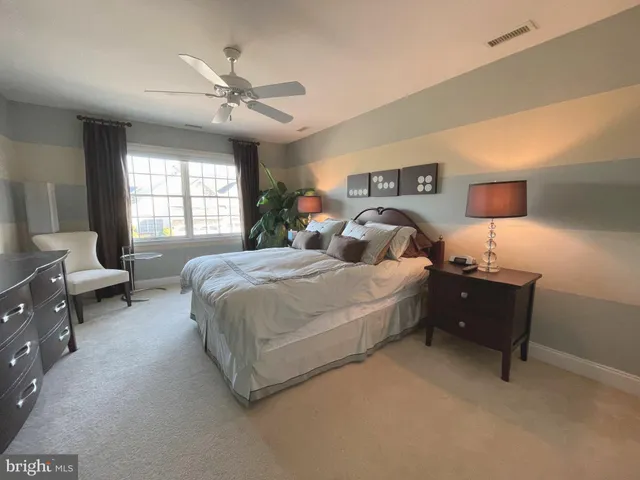 a spacious bedroom with a bed and a couch