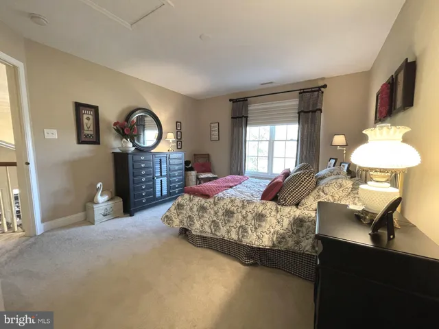 a bed room with a bed mirror and a window