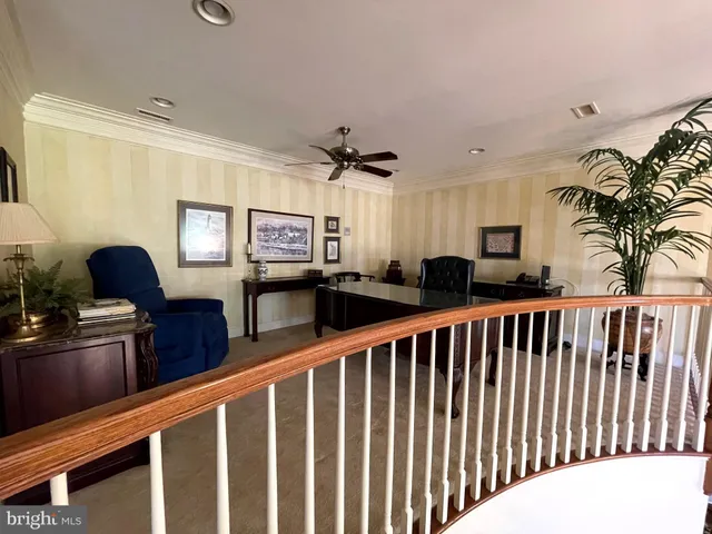 a view of a workspace with furniture and window