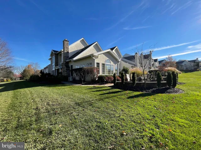 a front view of a house with swimming pool and sitting area
