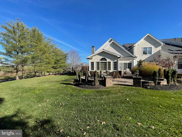 a view of a house with a yard covered with snow in the background
