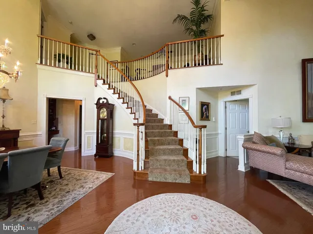 a view of entryway livingroom and hall with wooden floor