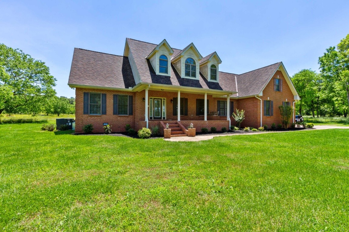 1930 Alsup Mill Road Lascassas, TN 37085 - Photo 1 of 50 a front view of a house with garden