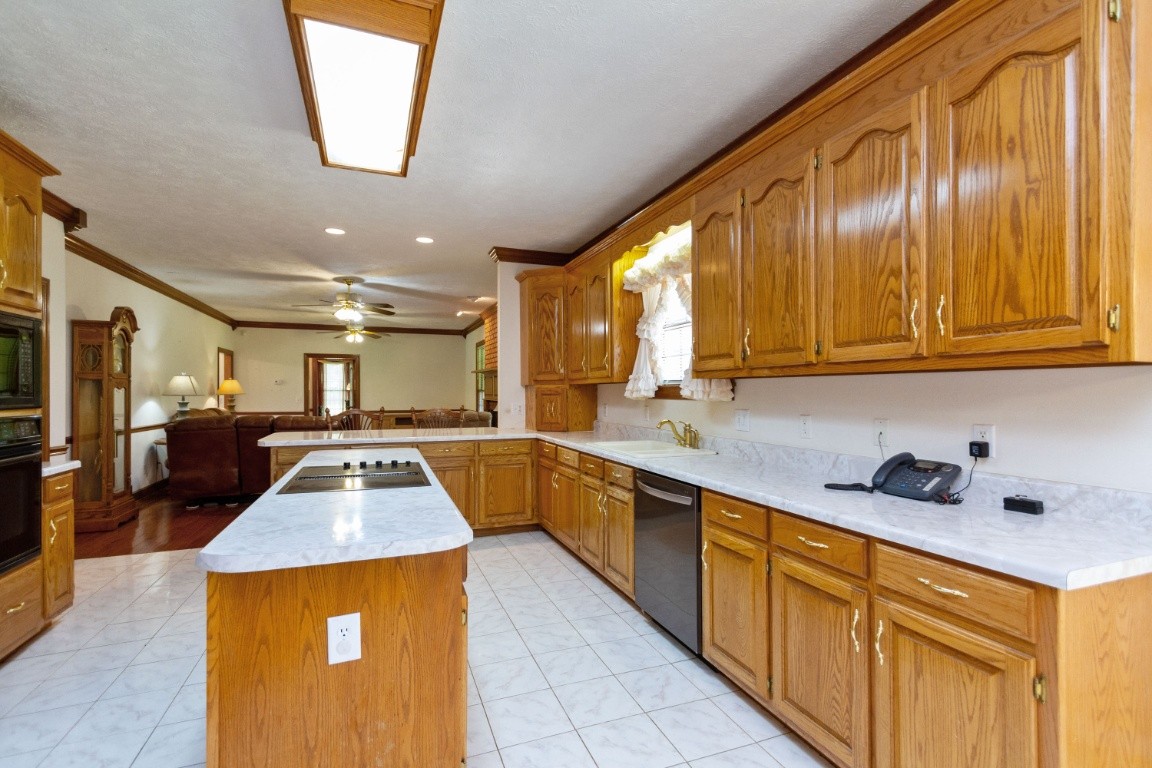 1930 Alsup Mill Road Lascassas, TN 37085 - Photo 16 of 50 a kitchen with stainless steel appliances granite countertop wooden cabinets a sink and a stove
