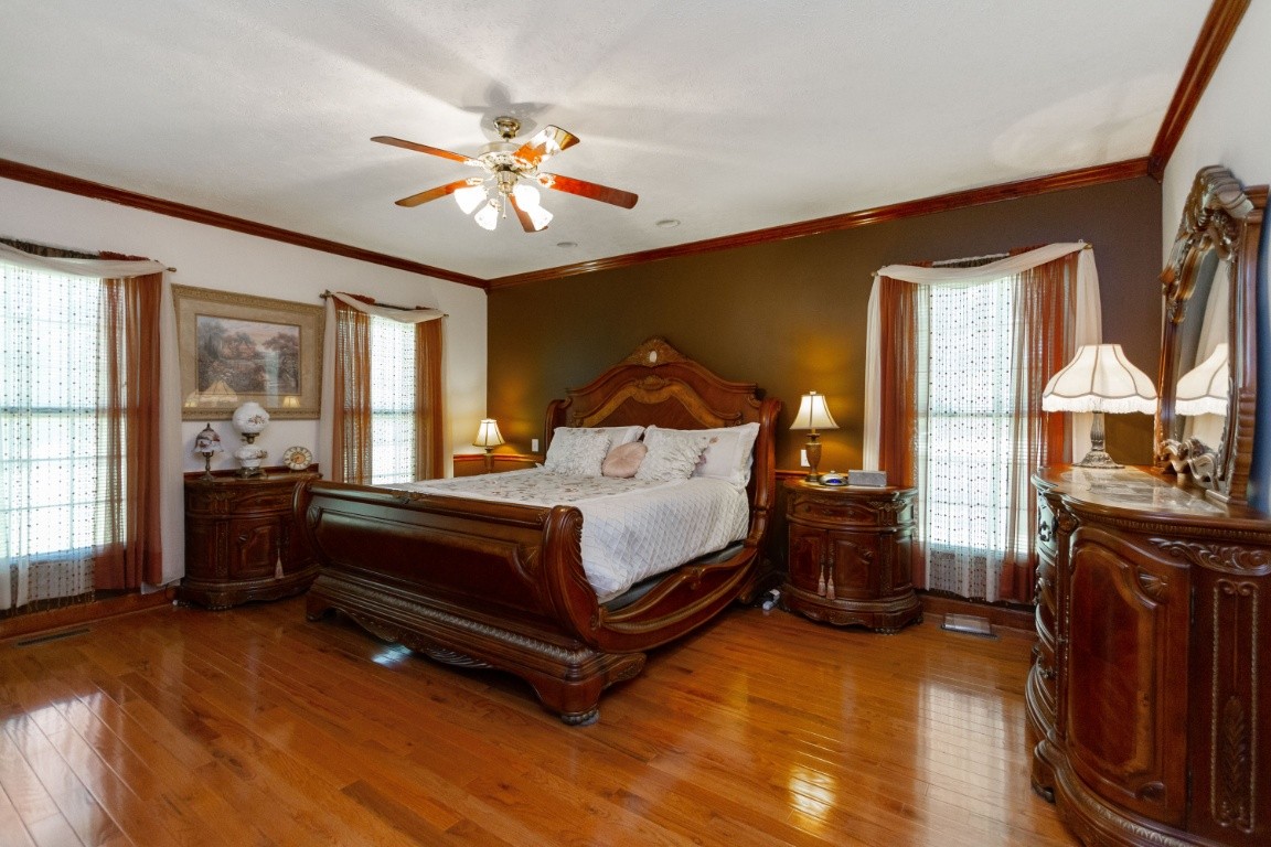 1930 Alsup Mill Road Lascassas, TN 37085 - Photo 17 of 50 a spacious bedroom with a bed and dresser with mirror
