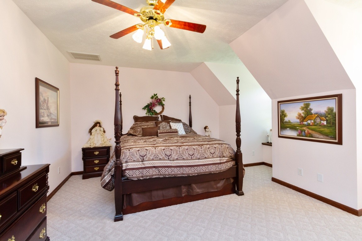 1930 Alsup Mill Road Lascassas, TN 37085 - Photo 24 of 50 a bedroom with a bed and a chandelier