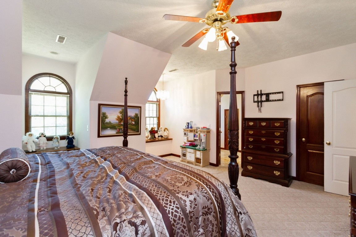 1930 Alsup Mill Road Lascassas, TN 37085 - Photo 25 of 50 a bedroom with bed and a chandelier