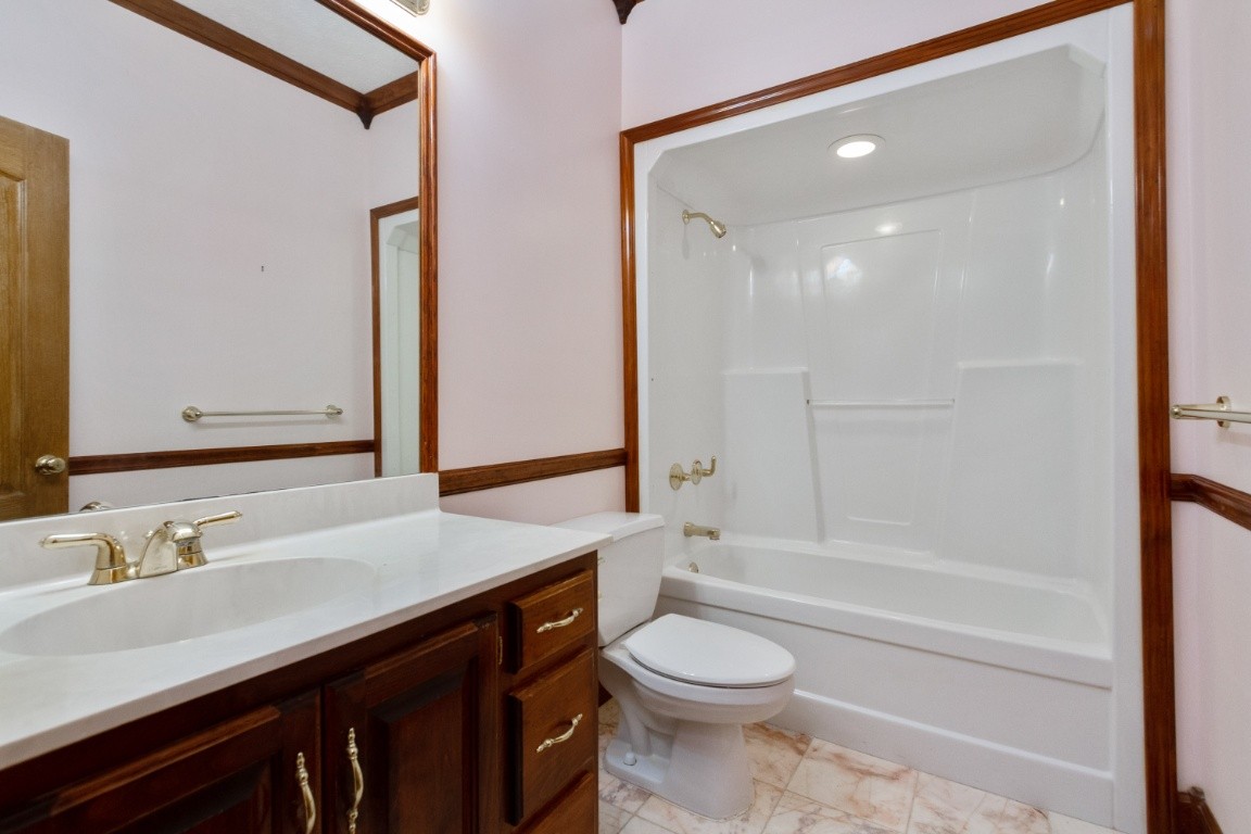 1930 Alsup Mill Road Lascassas, TN 37085 - Photo 27 of 50 a bathroom with a granite countertop sink a toilet and shower
