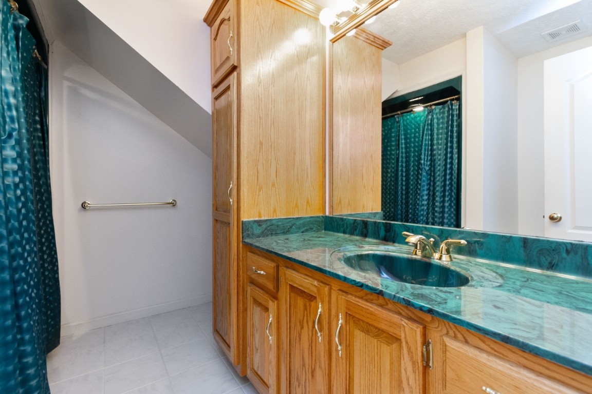 1930 Alsup Mill Road Lascassas, TN 37085 - Photo 30 of 50 a bathroom with a granite countertop sink and a mirror