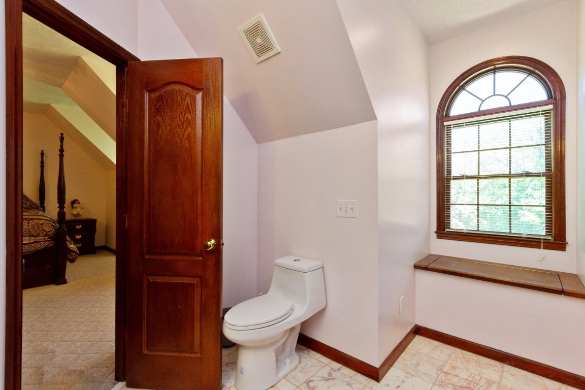 1930 Alsup Mill Road Lascassas, TN 37085 - Photo 32 of 50 a bathroom with a toilet a sink a mirror a window and a shower
