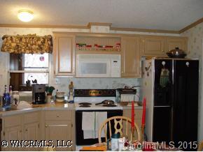 619 Short Ridge Lane Clyde, NC 28721 - Photo 7 of 9 a kitchen with stainless steel appliances granite countertop a refrigerator and a stove