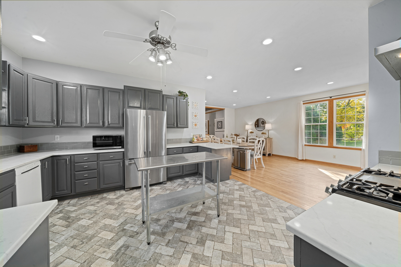 43W140 Campton Hills Road Elburn, IL 60119 - Photo 9 of 54 a kitchen with stainless steel appliances a stove a sink a oven a refrigerator cabinets and dining table