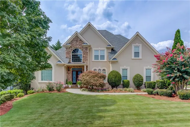 a front view of house with yard and green space