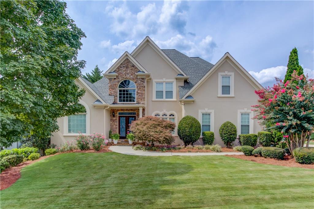 a front view of house with yard and green space