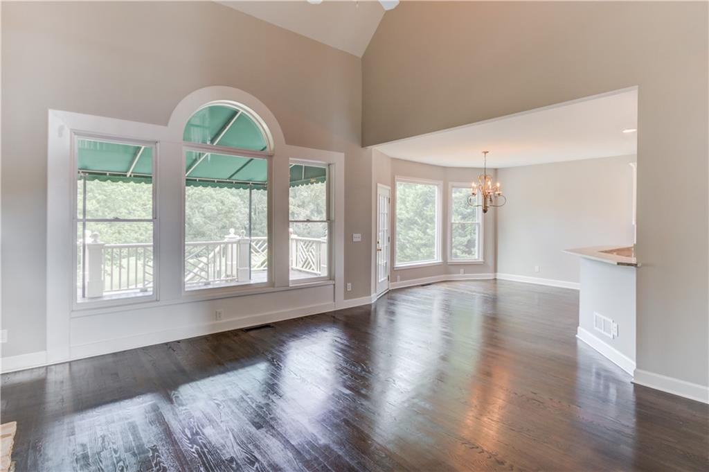 2092 Bakers Mill Road Dacula, GA 30019 - Photo 12 of 65 a view of an empty room with wooden floor and a window