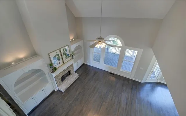 a kitchen with granite countertop white cabinets and window