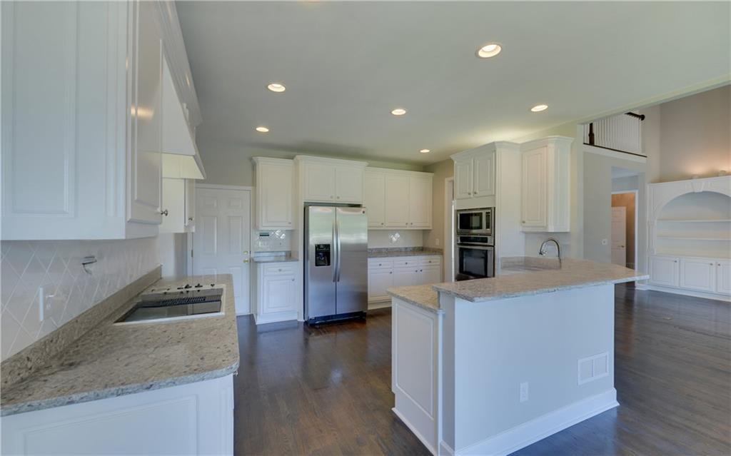 2092 Bakers Mill Road Dacula, GA 30019 - Photo 15 of 65 a kitchen with stainless steel appliances granite countertop a refrigerator and a stove