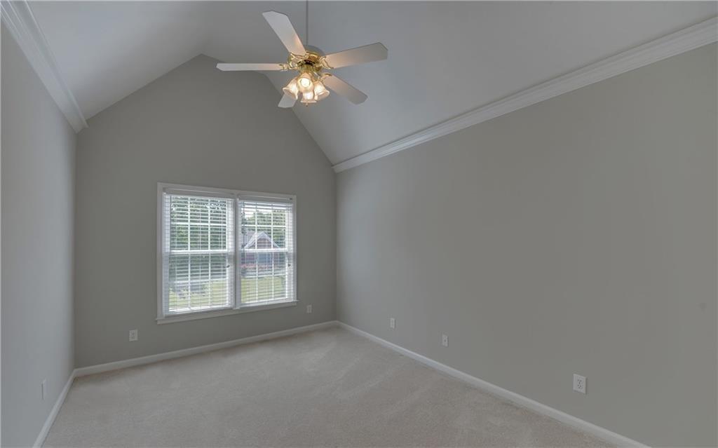 2092 Bakers Mill Road Dacula, GA 30019 - Photo 24 of 65 an empty room with a chandelier fan and a window