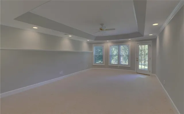 a view of a livingroom with a ceiling fan and window