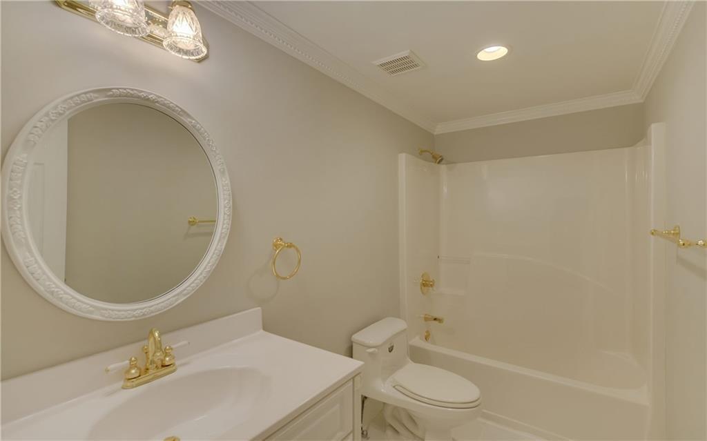 2092 Bakers Mill Road Dacula, GA 30019 - Photo 31 of 65 a bathroom with a sink a toilet and a mirror