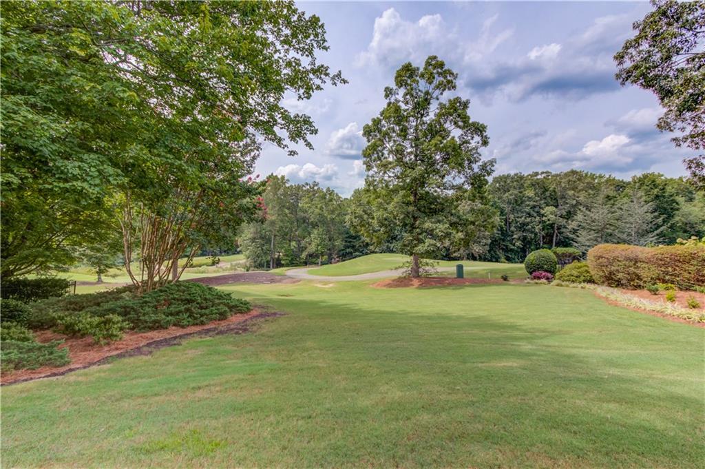 2092 Bakers Mill Road Dacula, GA 30019 - Photo 41 of 65 a swimming pool with wooden fence and trees