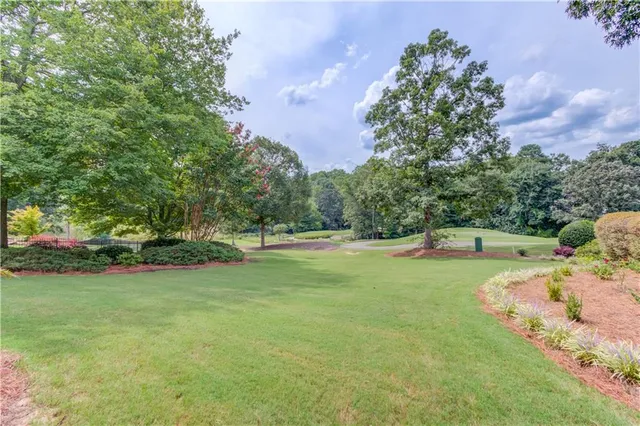 a view of a big yard with lots of green space and plants