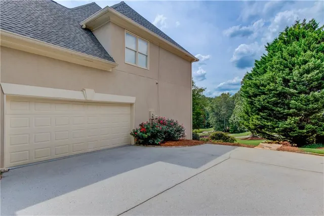 a view of a house with a yard and a garage
