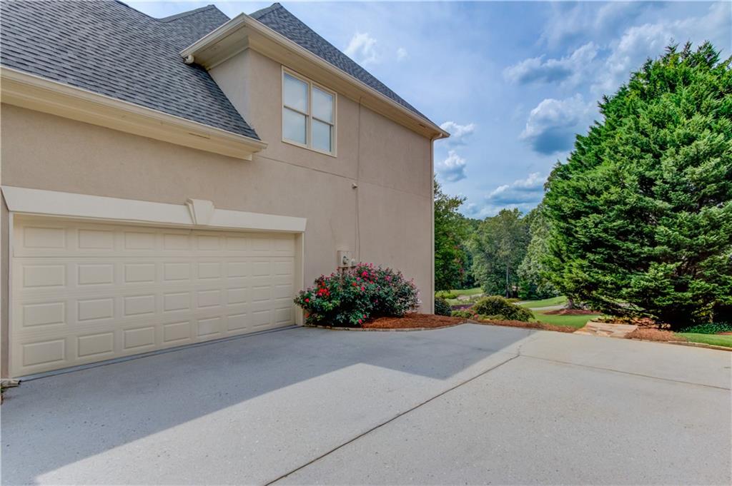 2092 Bakers Mill Road Dacula, GA 30019 - Photo 5 of 65 a view of a house with a yard and a garage