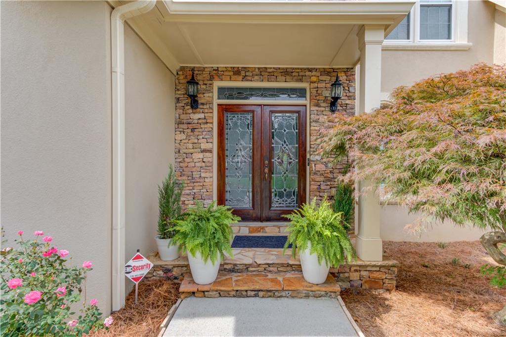 2092 Bakers Mill Road Dacula, GA 30019 - Photo 6 of 65 a potted plant sitting in front of a house