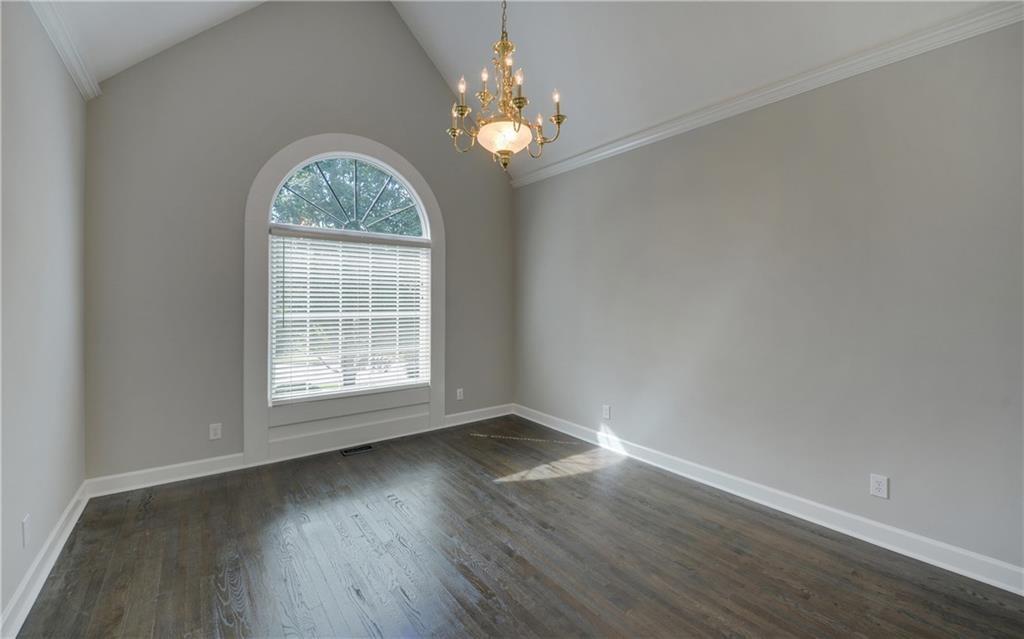 2092 Bakers Mill Road Dacula, GA 30019 - Photo 9 of 65 a view of an empty room with wooden floor and a window